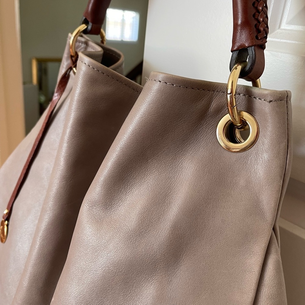 Gently used taupe soft leather hobo bag. Shows minimal signs of wear.